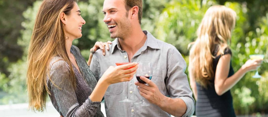 young-couple-drinking-cocktail-at-party